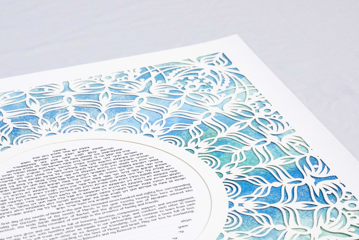 Blue and green side angle view of papercut lace ketubah